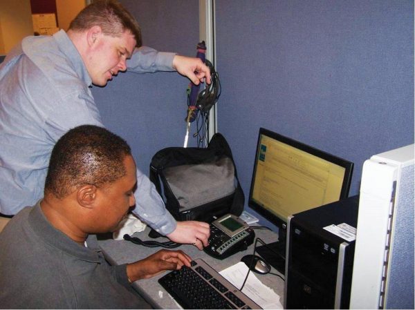 Man learning to use new assistive technological device